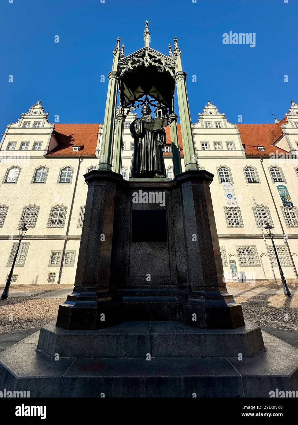 Martin Luther memorial designed by Schadow on the Market Square with the Altes Rathaus in Lutherstadt Wittenberg, Saxony-Anhalt, Germany - Smartphone Captured Stock Image