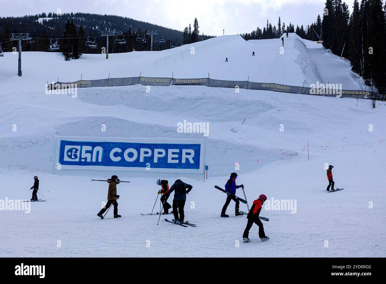 Denver, Colorado, USA. 24th Oct, 2024. Skiers and snowboarders walk beneath the Superpipe at Copper Mountain's Center Village, Monday, Mar. 20, 2023, in Summit County. The Olympic-sized halfpipe is 22-feet tall in nearly 550-feet in length with 18-degree pitch. (Credit Image: © Hugh Carey/Colorado Sun via ZUMA Press Wire) EDITORIAL USAGE ONLY! Not for Commercial USAGE! Stock Photo