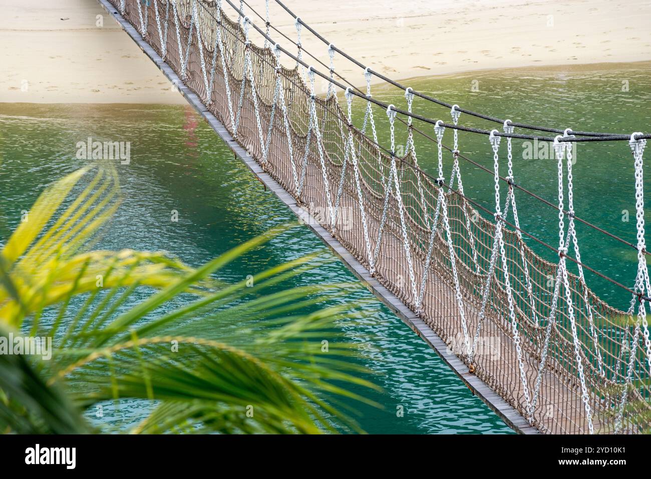Bridge Rope Over Water scenic hanged pedestrian rope bridge over blue sea water Stock Photo ...