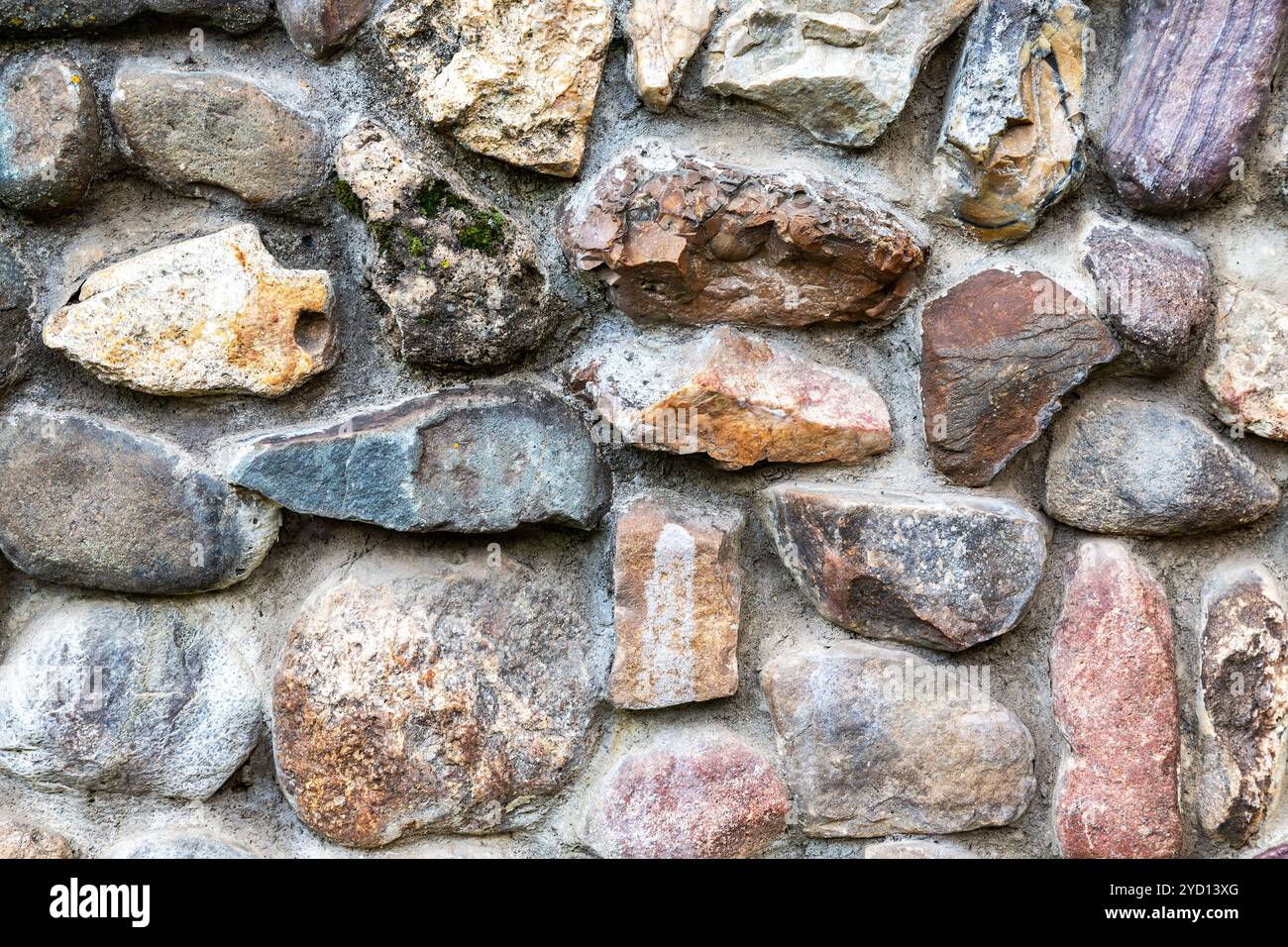 Weathered grunge rough stone wall as background texture Stock Photo