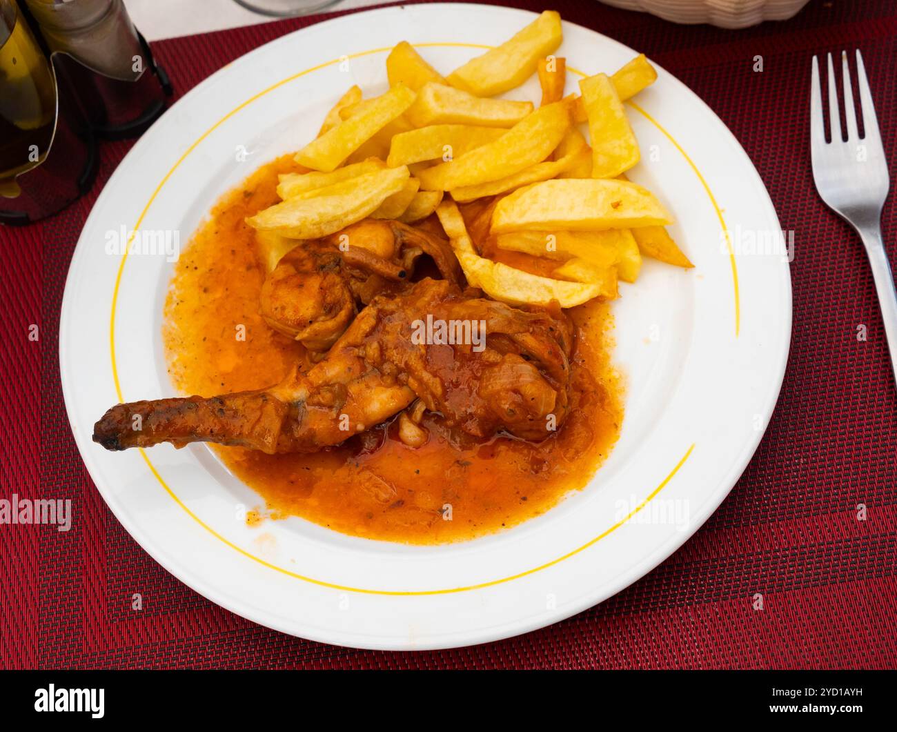 Braised rabbit served with potato garnish Stock Photo