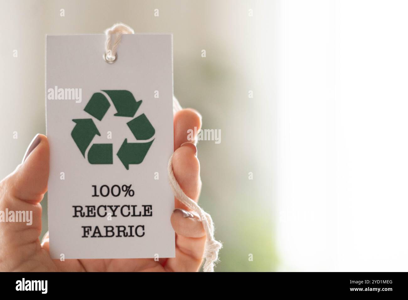 Materials For Rycle Label Recyclable product concept. Hand takes a label with the words 100 ...