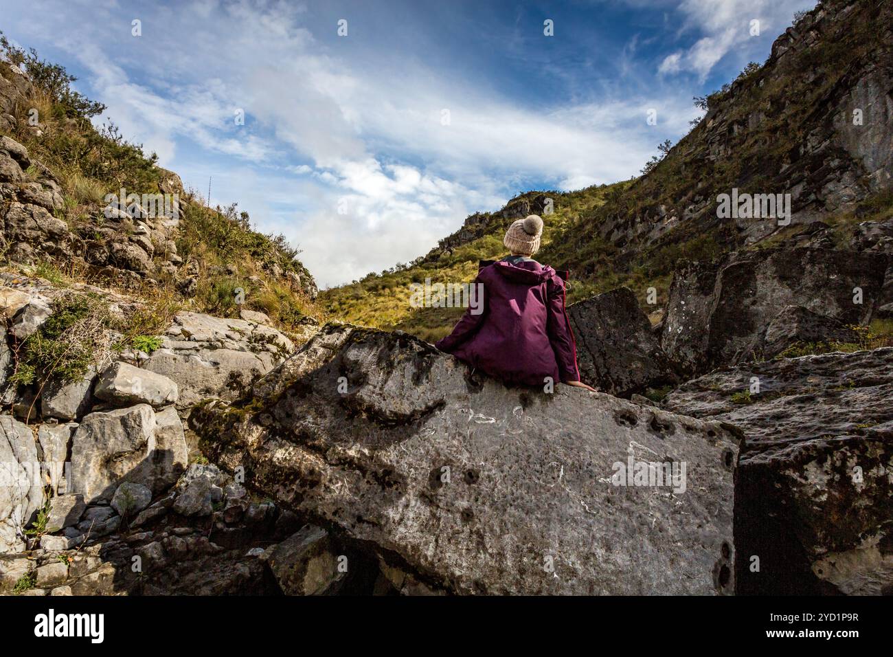 Woman sitting on rock with sea fossils more than 1200 mtrs above sea Stock Photo