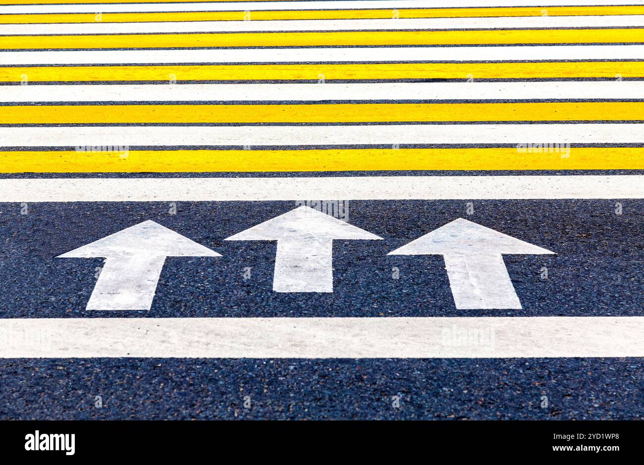 Pedestrian crossing with arrows, white and yellow stripes Stock Photo ...