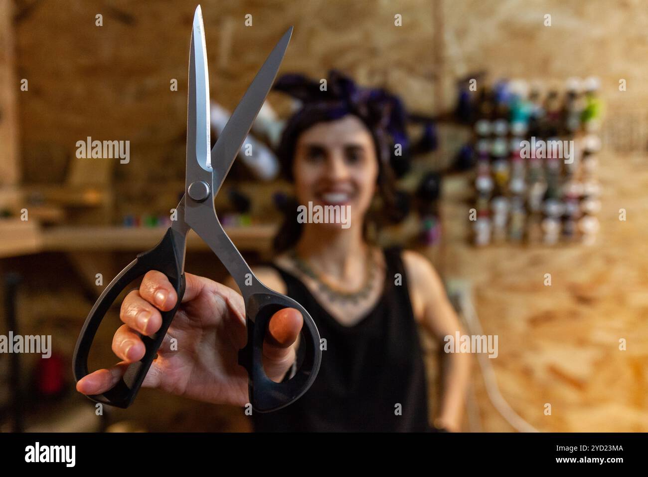 Fashion designer showing sewing scissors Stock Photo - Alamy