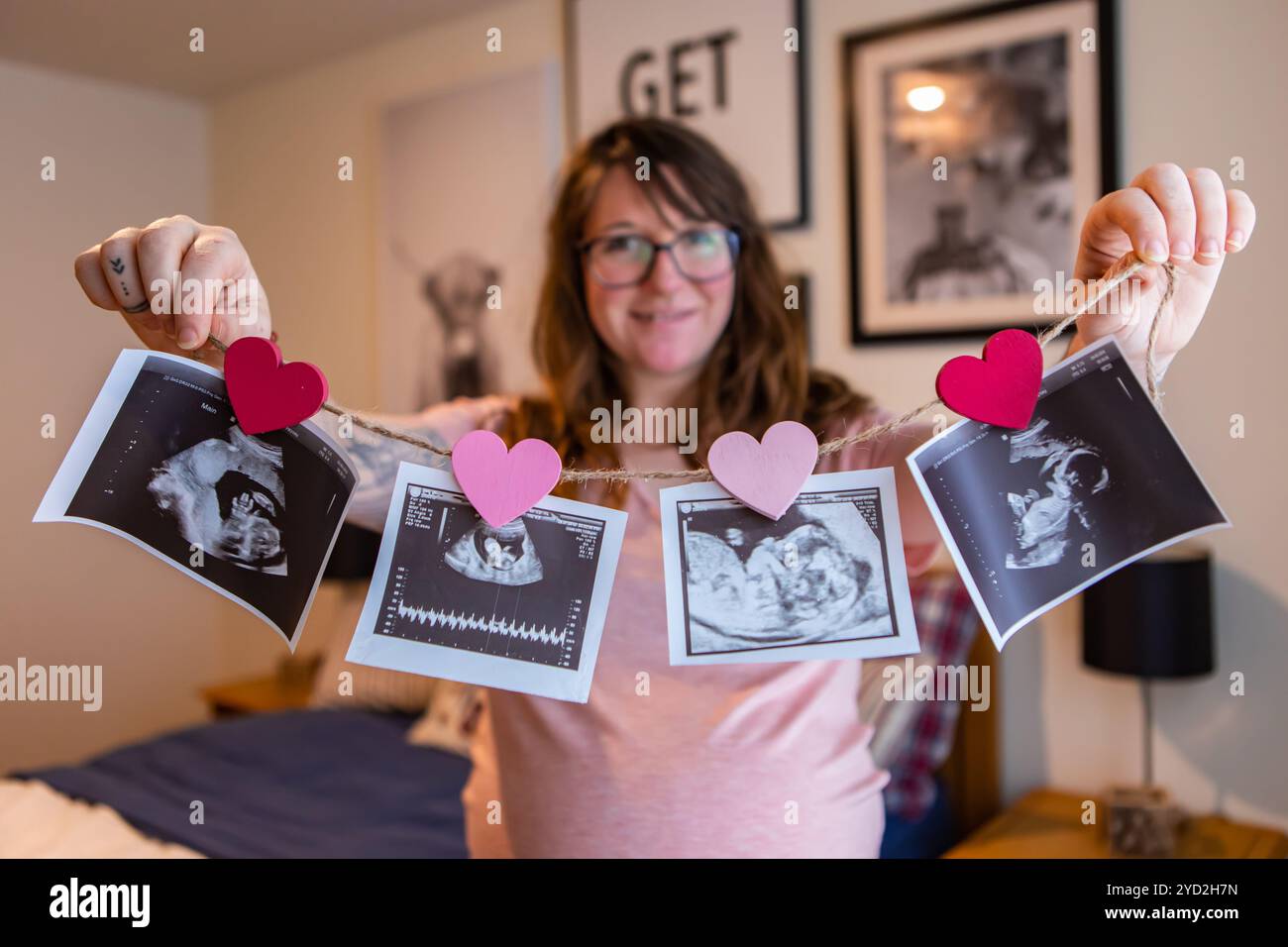 Pregnant woman holds echography scans Stock Photo