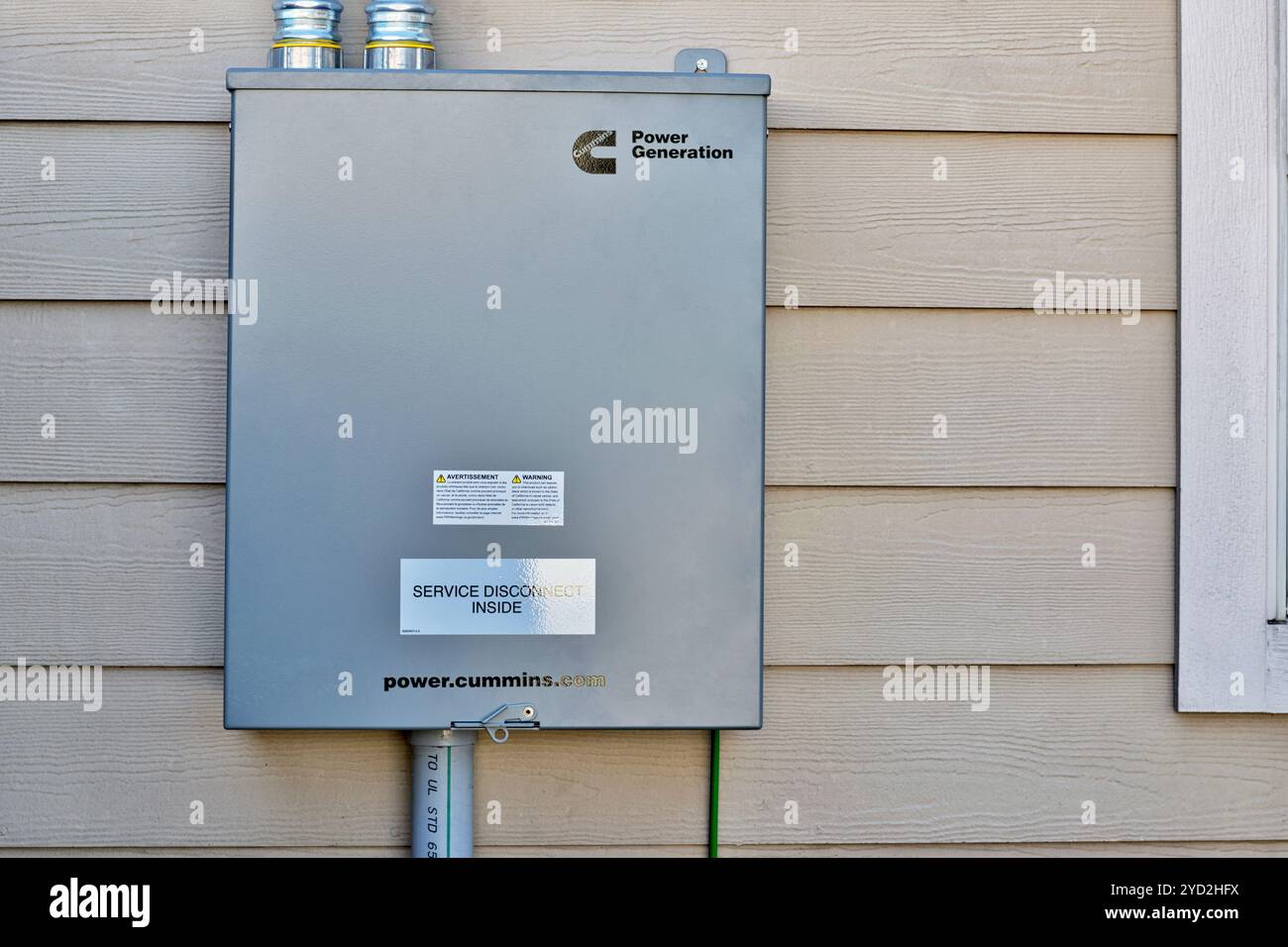 Houston, Texas USA 10-17-2024: Cummins standby generator transfer switch disconnect box wall. Stock Photo