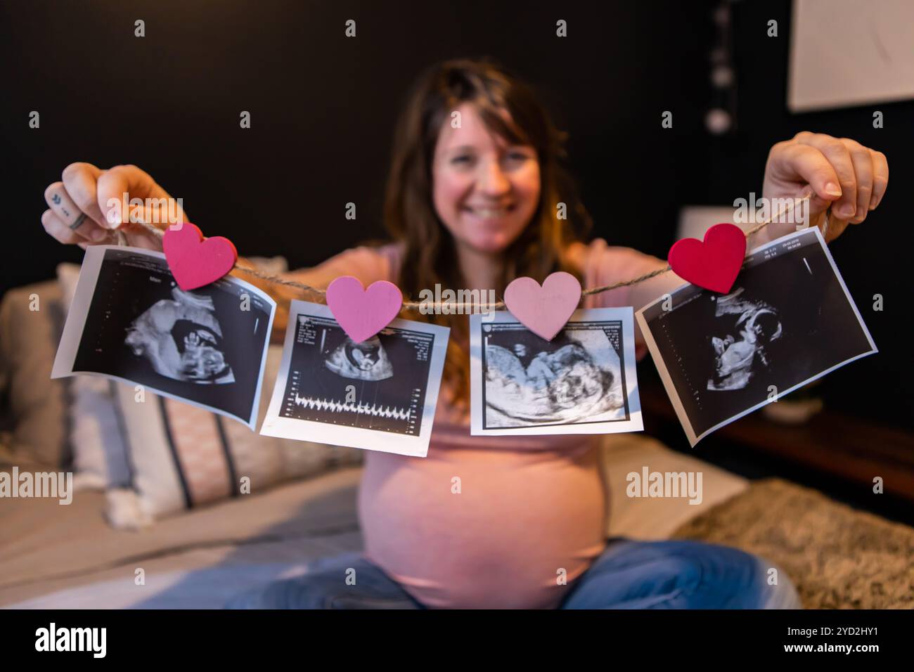 Pregnant woman holds echography scans Stock Photo