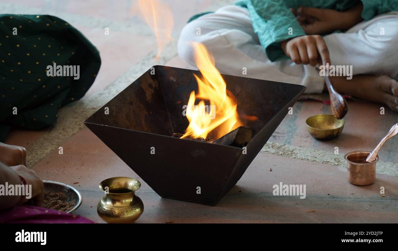 Regaged Ritual A traditional Indian family engaged in a sacred Yagya ritual to ...