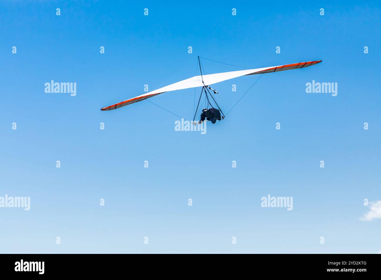 Hang glider flight against the blue sky Stock Photo