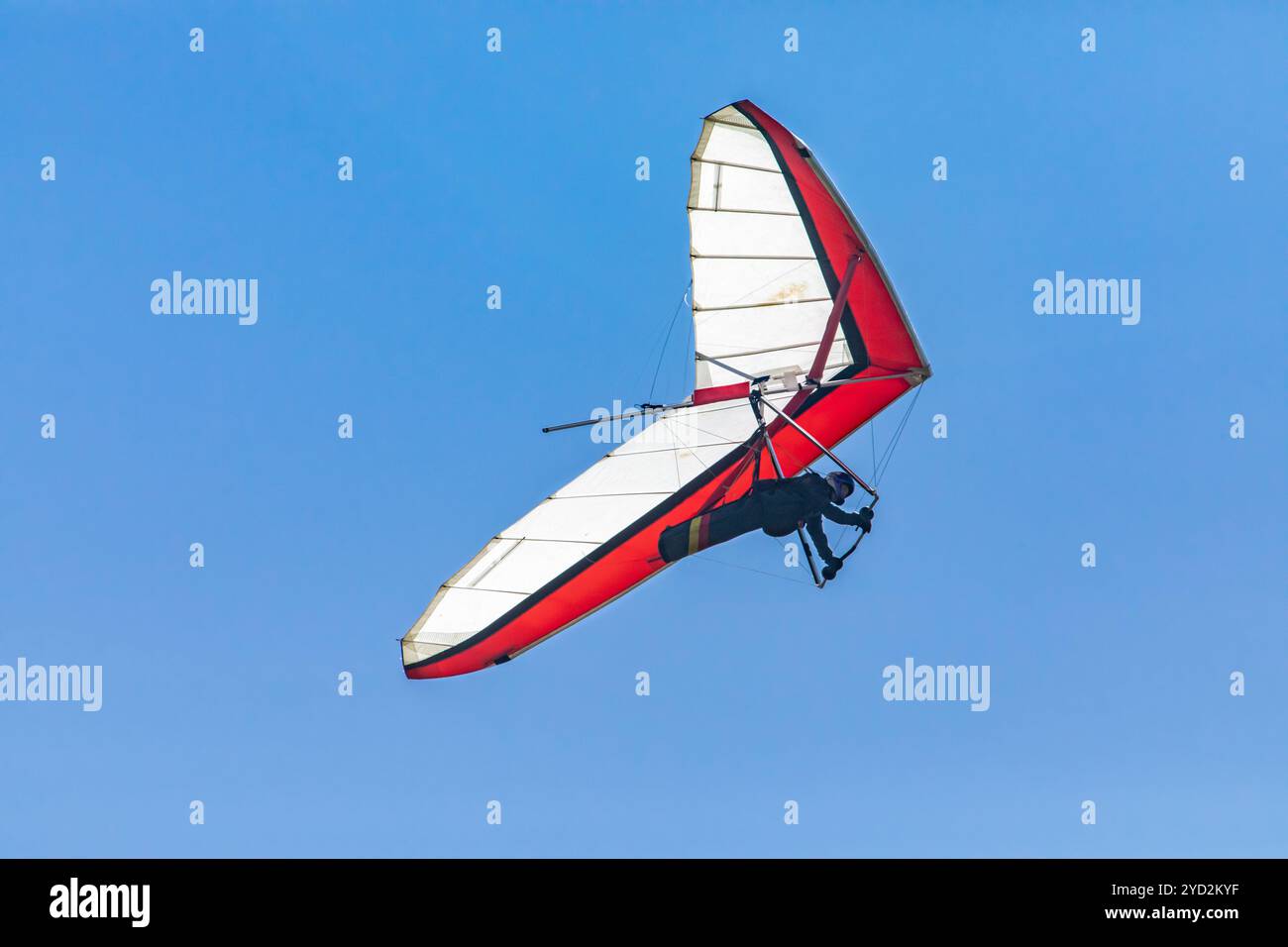 Hang glider flight against the blue sky Stock Photo