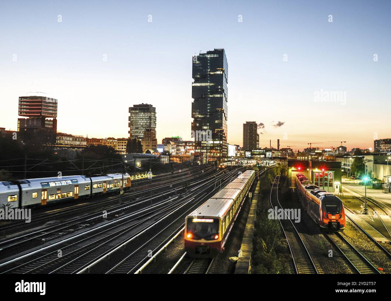 Sunset at the Modersohn Bridge, view of railway tracks, trains and the 140 metre high Amazon office tower Edge East Side, Berlin, 23.10.2024., Berlin Stock Photo