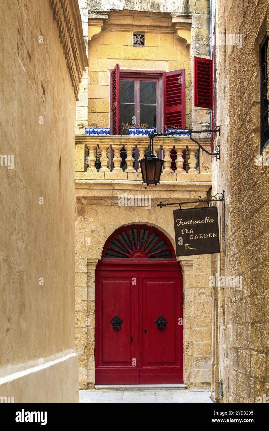 Mdina, Malta, 22 December, 2023: narrow alley in the old town of Medina with restaurant and colourful door, Europe Stock Photo