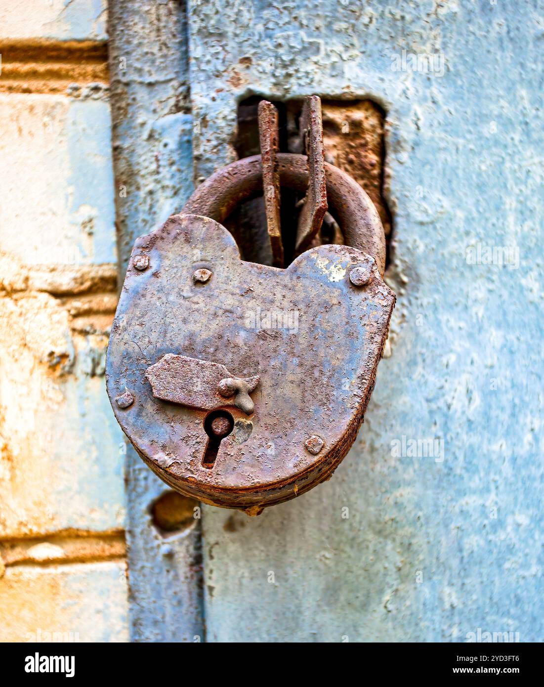 Rusty padlock on an old metal door Stock Photo