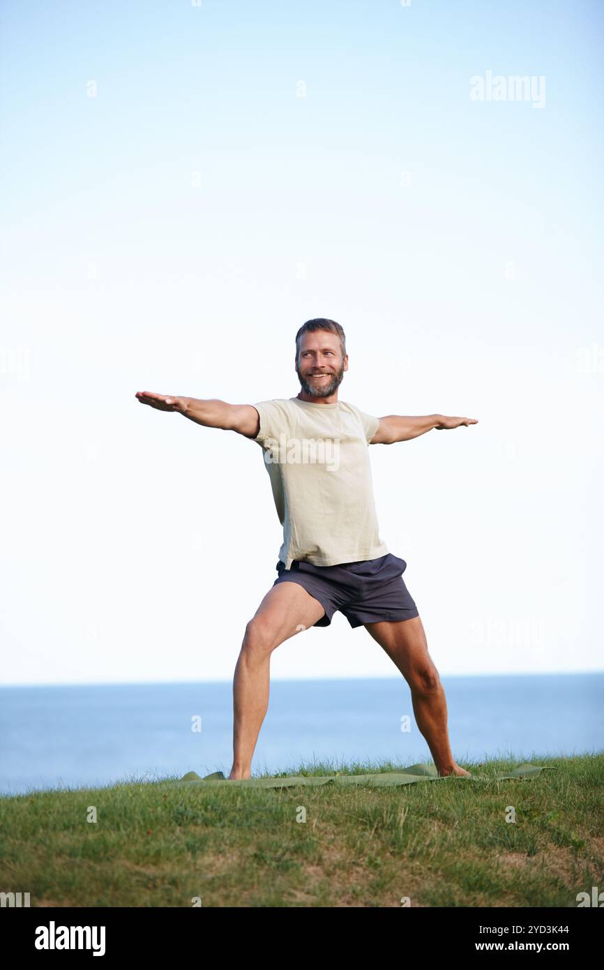 Male yogi stretching on grass hi-res stock photography and images - Alamy