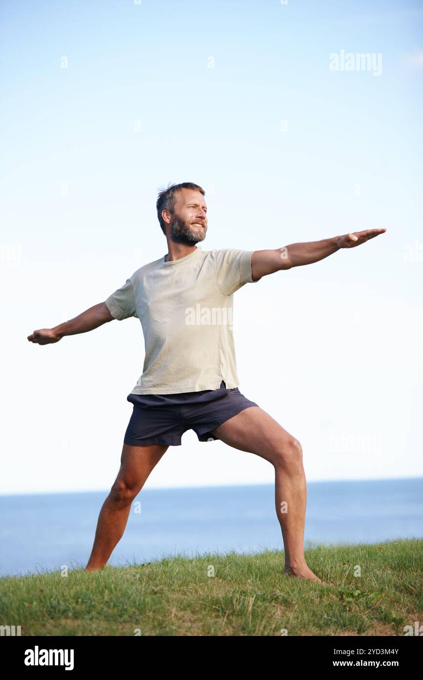 Male yogi stretching on grass hi-res stock photography and images - Alamy