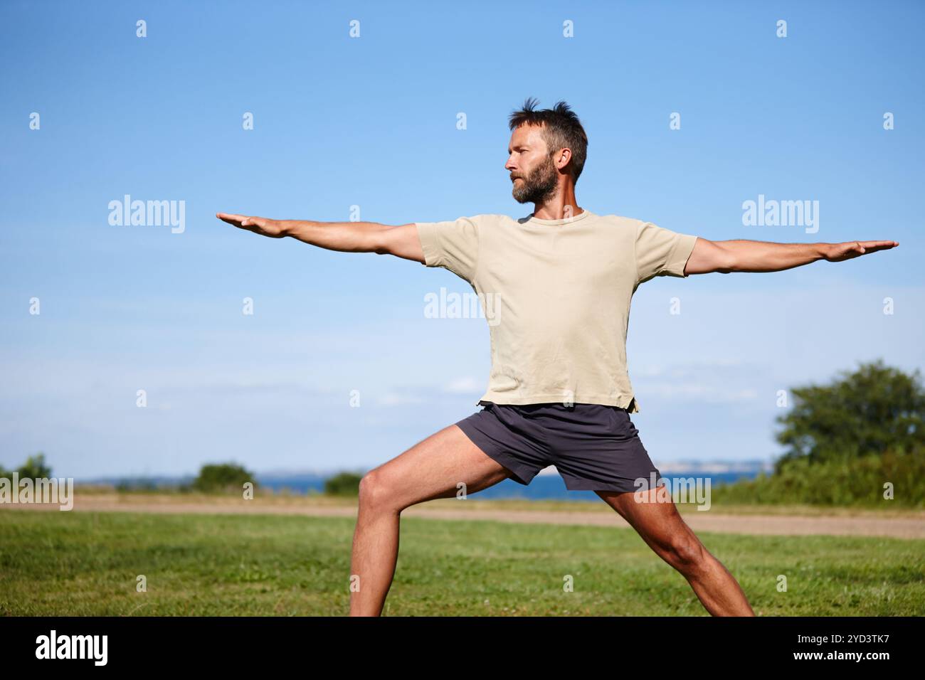 Male yogi stretching on grass hi-res stock photography and images - Alamy
