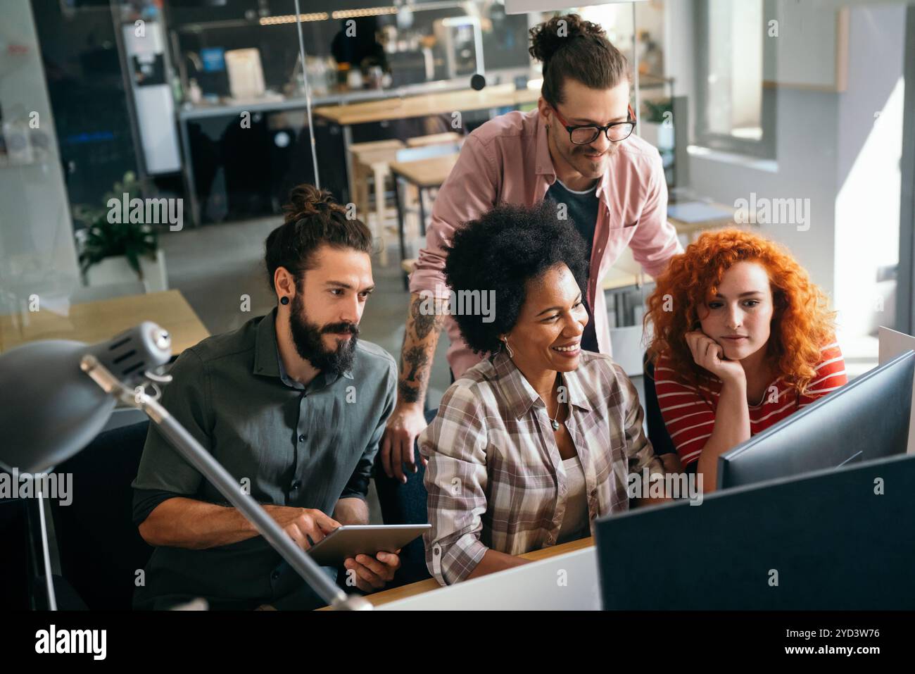 Mixed team of software engineers brainstorming ideas. Diverse app developers collaborating as group Stock Photo