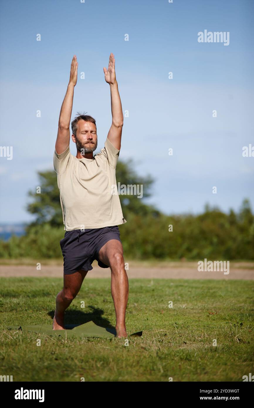 Male yogi stretching on grass hi-res stock photography and images - Alamy