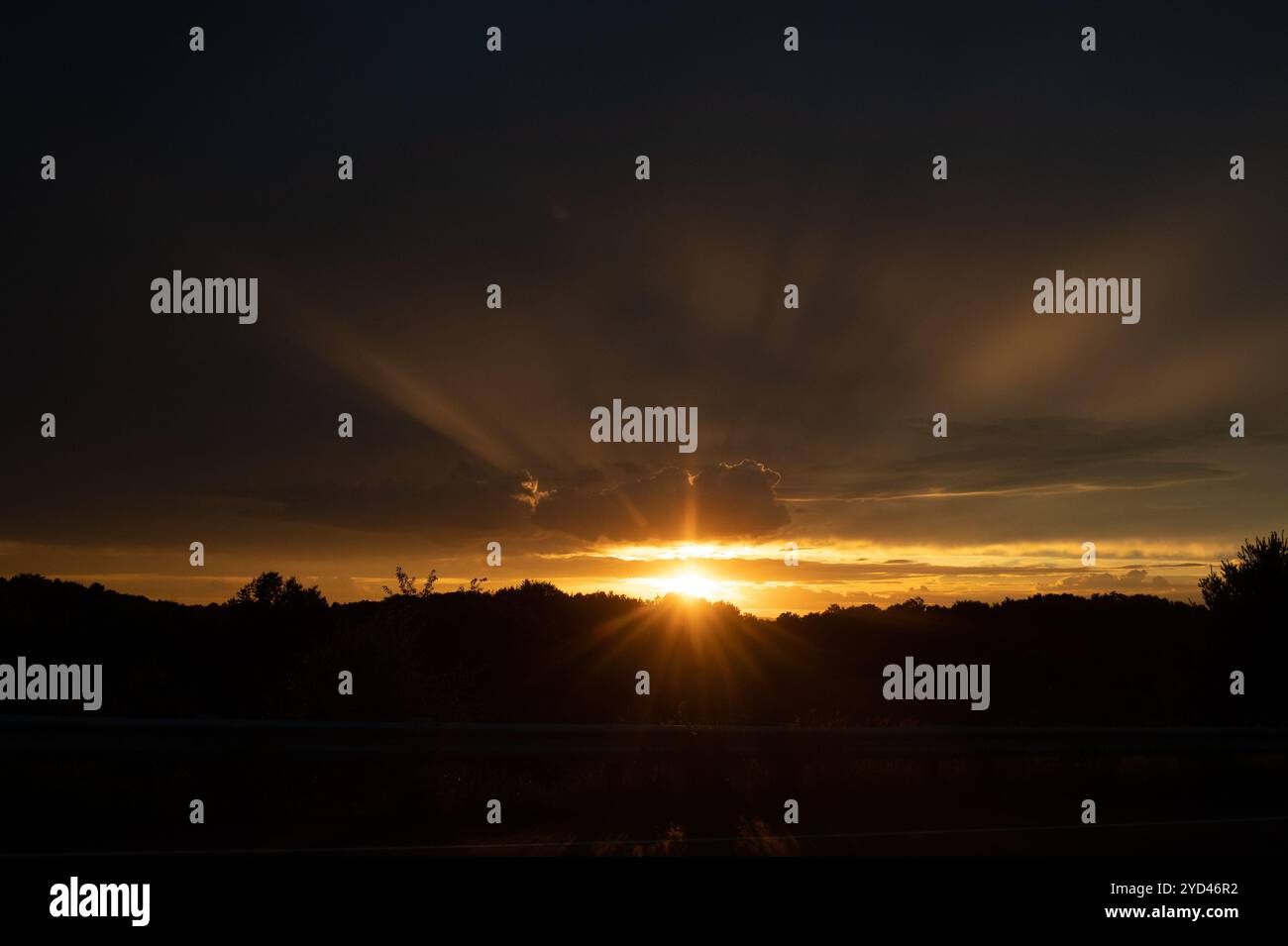 Dramatic sunset with dark sky and dark foreground Stock Photo