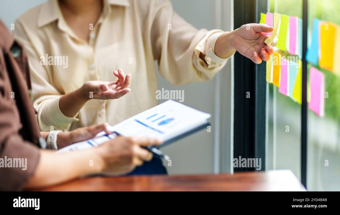 Startup team meeting in modern workplace with project ideas. Stock Photo