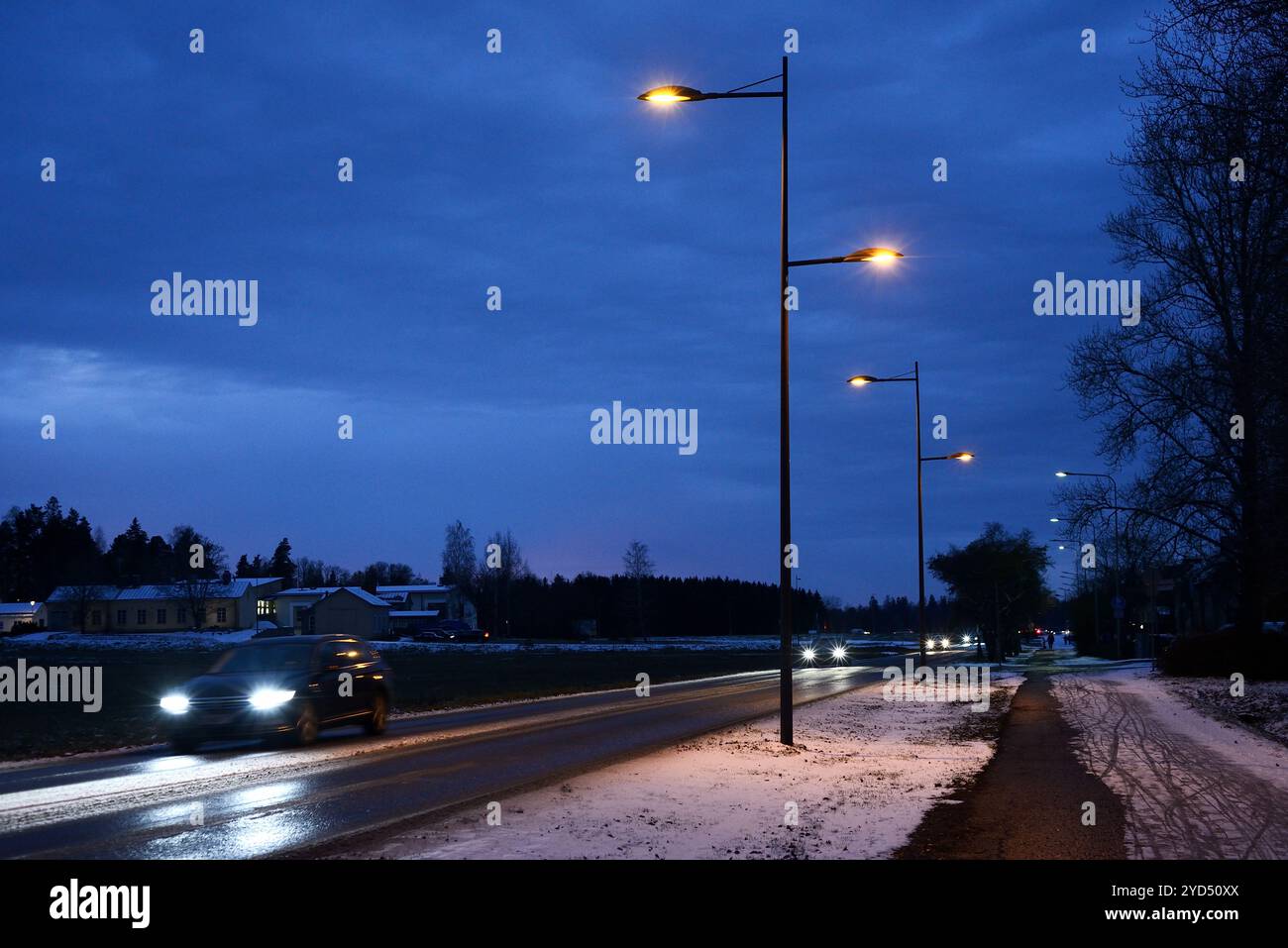 Night traffic of cars on the road in a small Finnish town Stock Photo