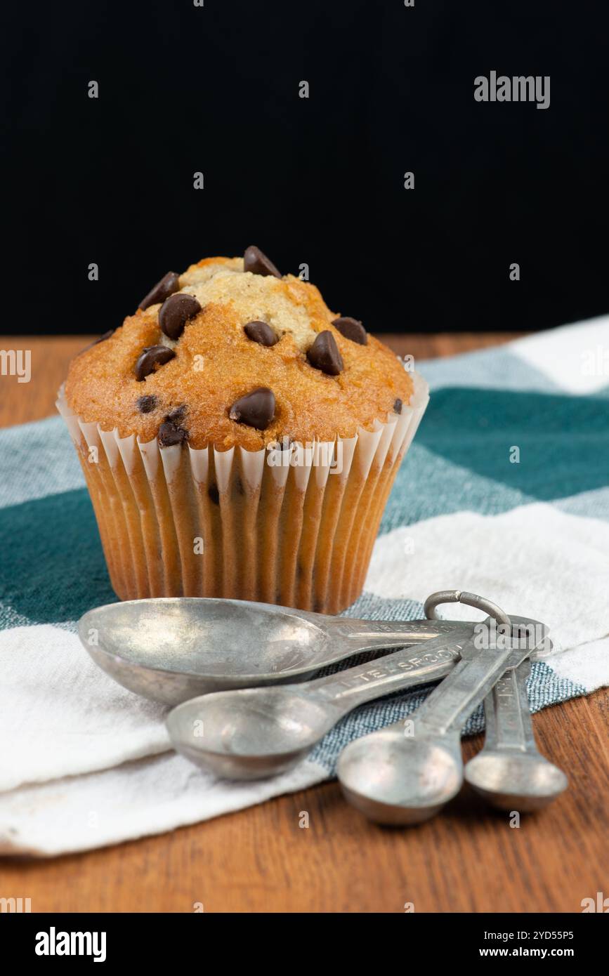 Chocolate chip muffin and measuring spoons Stock Photo