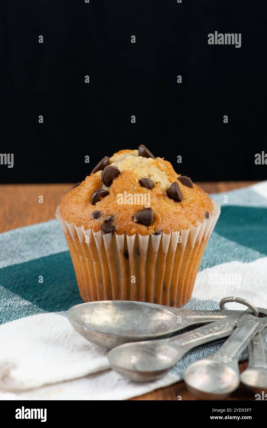 Chocolate chip muffin and measuring spoons Stock Photo