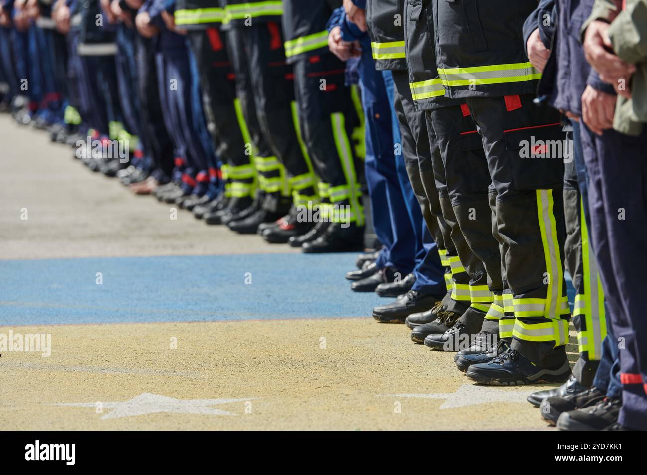 Intensive Session A group of firefighters lined up, saluting the flag, applauding in ...
