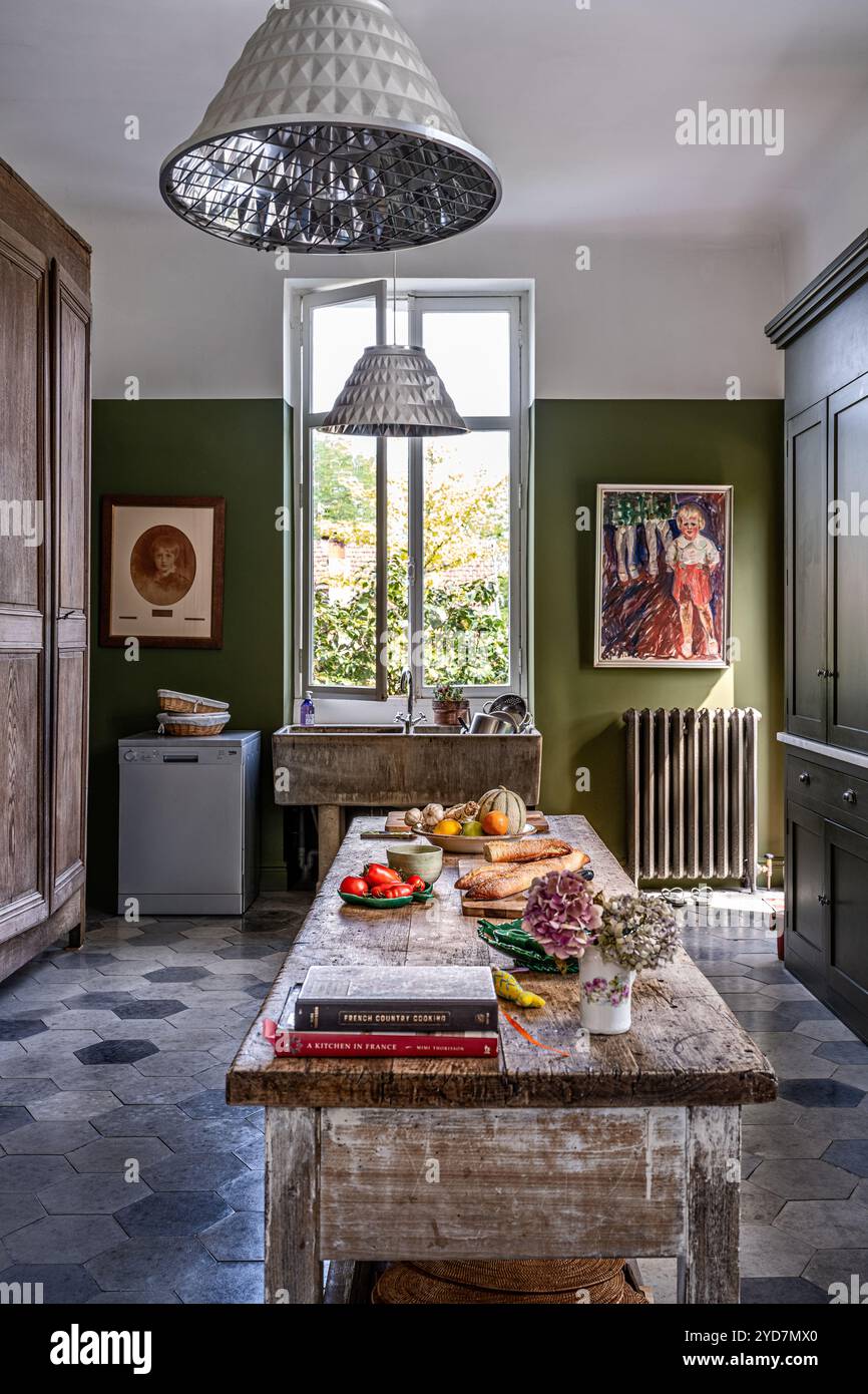 Food preparation on wooden table in olive green kitchen of updated ... - Green Updated Luxury