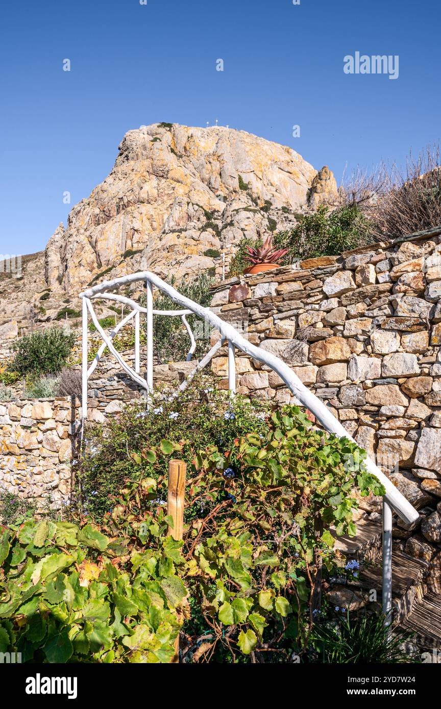 Railing on terraced steps with stone wall on the Island of Tinos in Greece Stock Photo