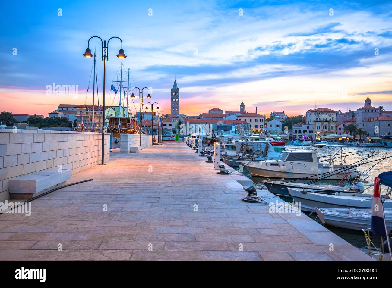 Historic town of Rab towers and sailing harbor sunset view Stock Photo