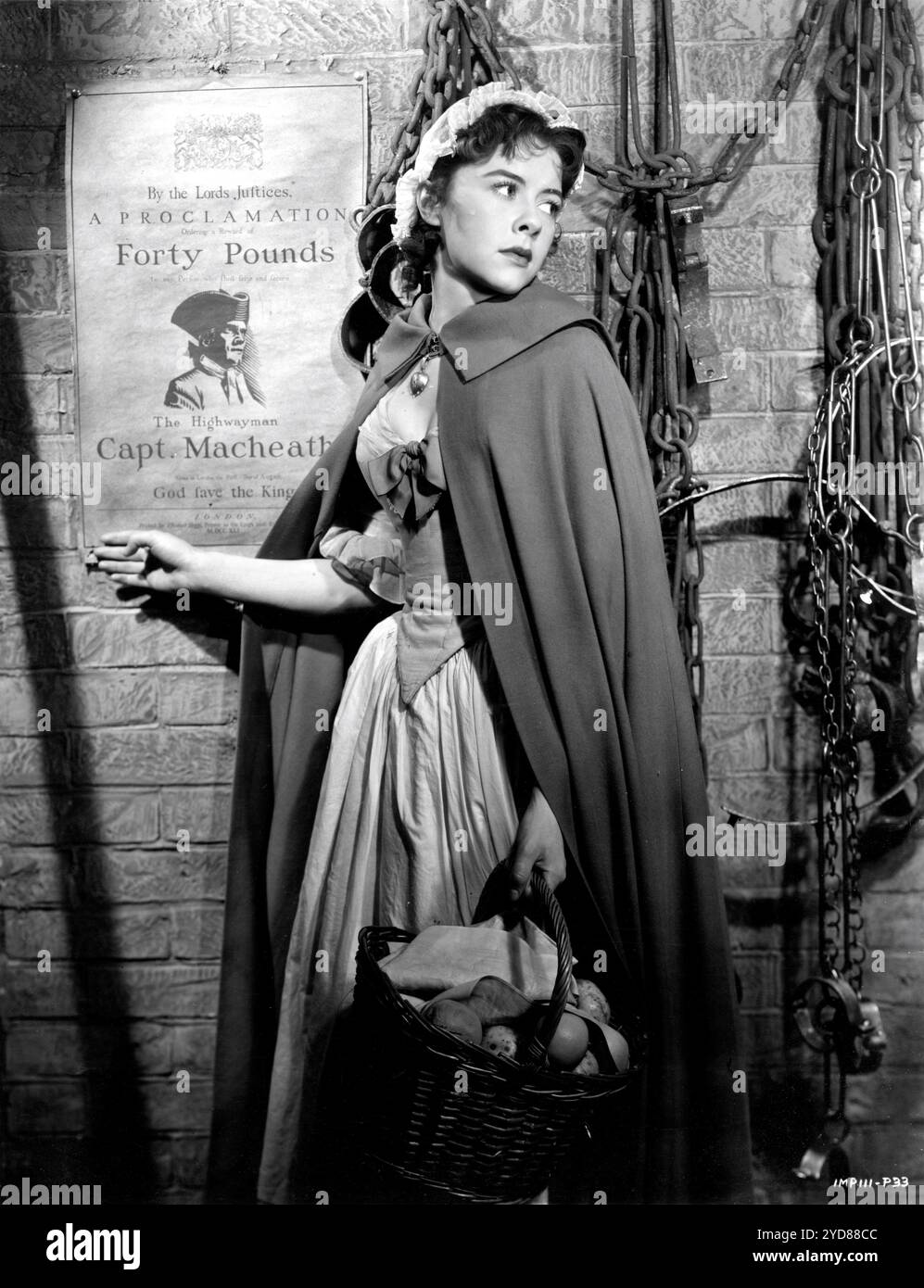 DOROTHY TUTIN as Polly Peachum portrait next to Wanted Poster for LAURENCE OLIVIER as Captain MacHeath the Highwayman in THE BEGGAR'S OPERA 1953 director PETER BROOK libretto John Gay writers Denis Cannan and Christopher Fry music Arthur Bliss costume design Georges Wakhevitch Herbert Wilcox Productions / British Lion Film Corporation Stock Photo