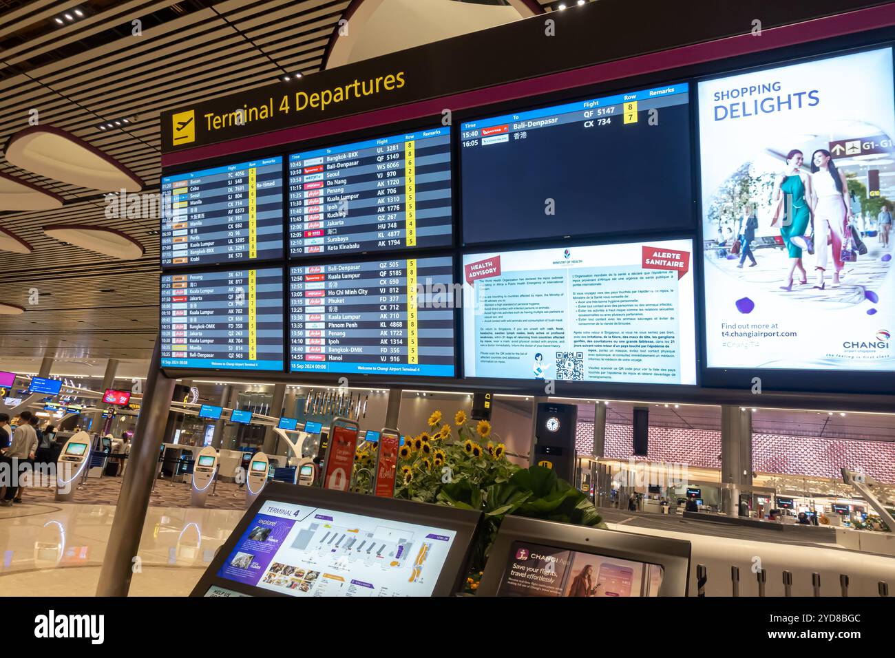 Singapore Changi Airport Terminal 4 departures flights information screen, health advisory, shopping delights advert Stock Photo