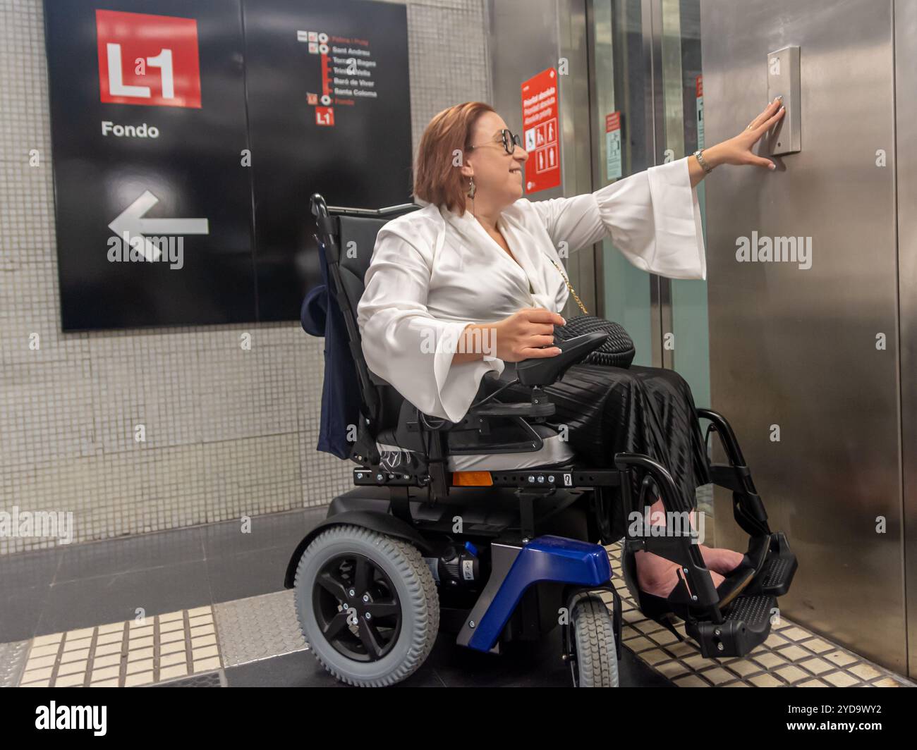 Accessible Metro Facilities: Wheelchair User Using Elevator Button ...
