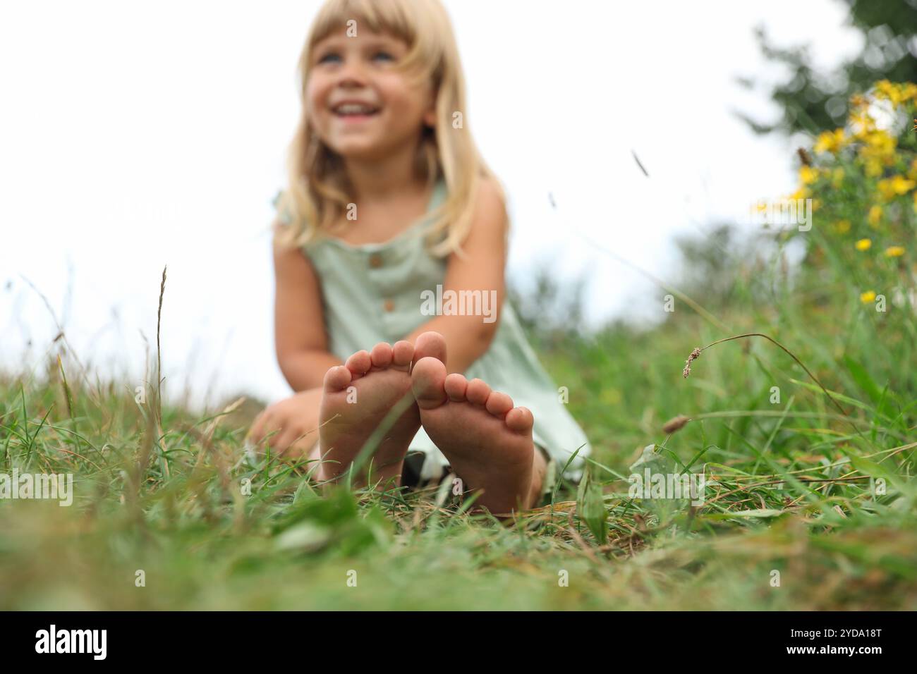 Barefoot Little Girl On Green Grass At Meadow Selective Focus Child barefoot-little-girl-on-green-grass-at-meadow-selective-focus-child