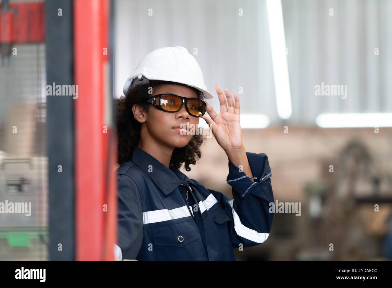 Portrait of a young female engineer in the welding robot industry ...