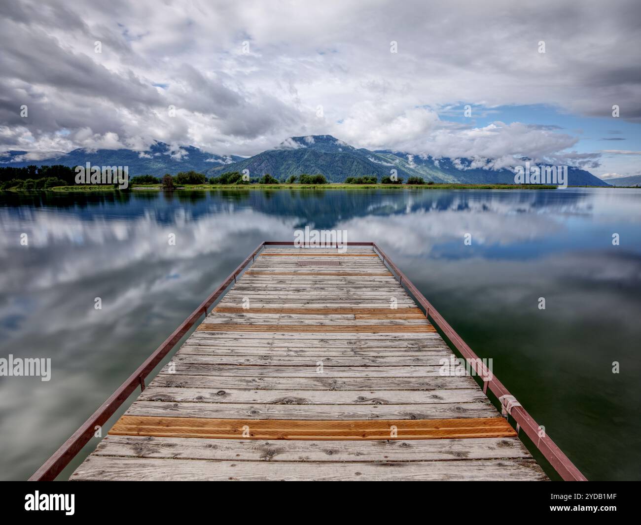 Landscape photo of dock on calm water. Stock Photo