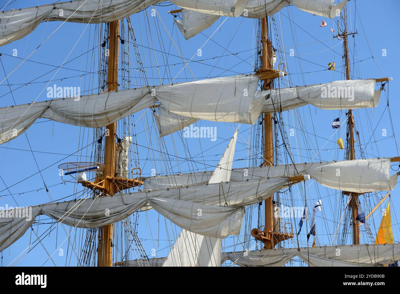 Close-up view of the intricate rigging, masts, and sails of a tall ship ...