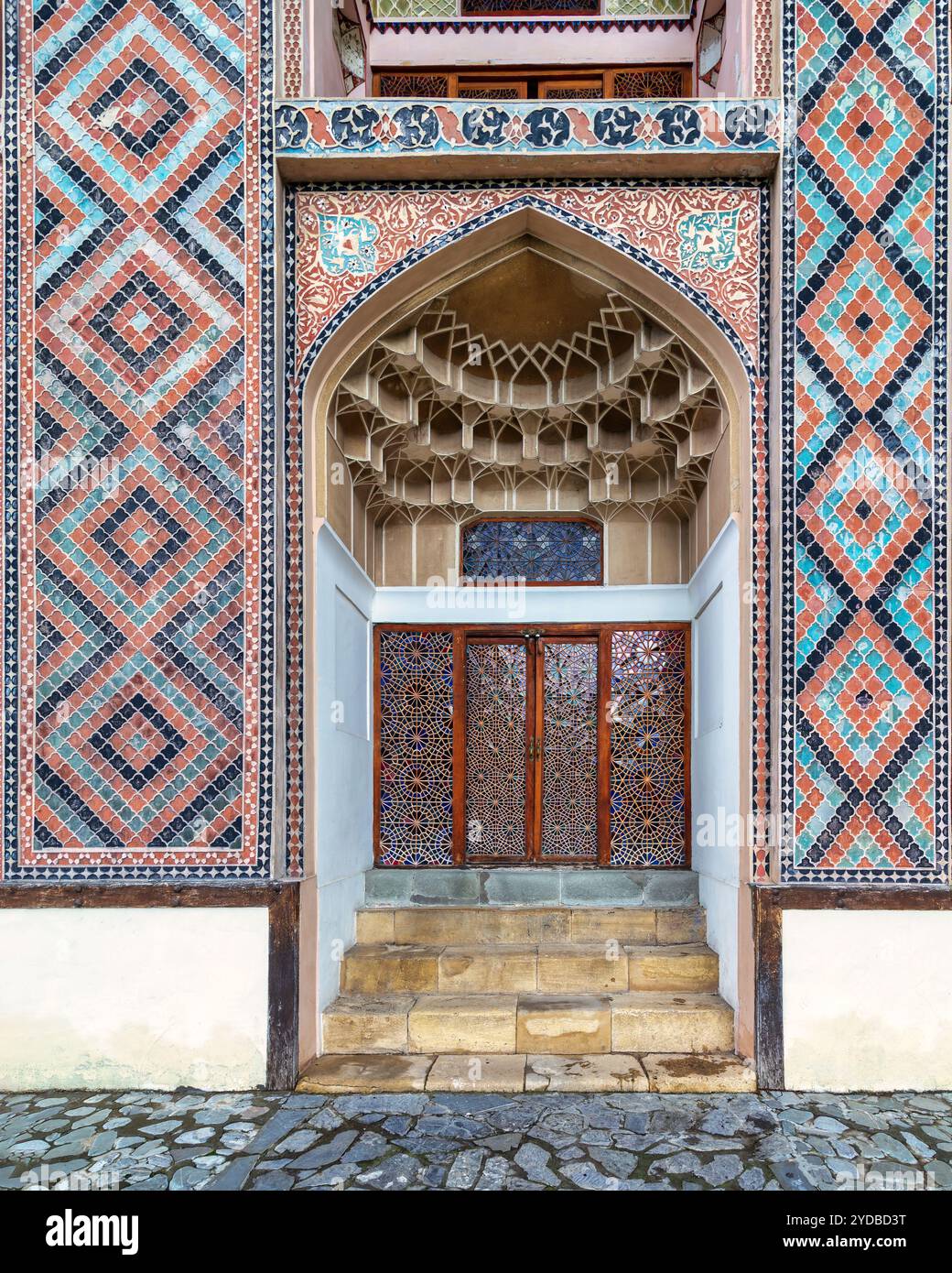 Detailed side entrance of Shaki Khan Palace, featuring vibrant tile patterns and elegant design in Shaki, Azerbaijan Stock Photo