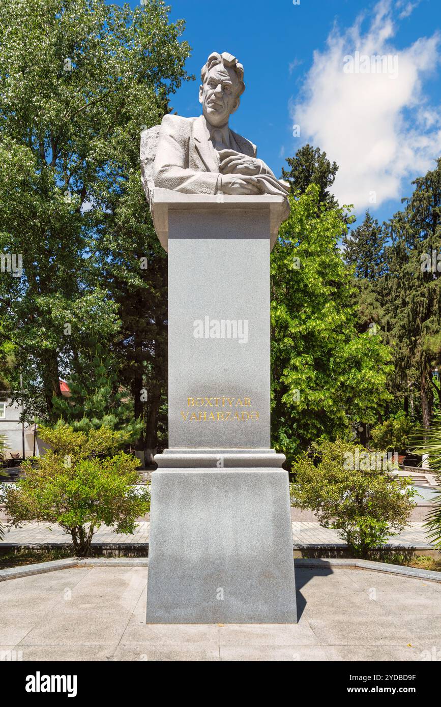 A statue of Bakhtiyar Vahabzadeh stands majestically in Shaki, Azerbaijan, celebrating the life and contributions of the renowned poet amid vibrant greenery and a tranquil setting Stock Photo