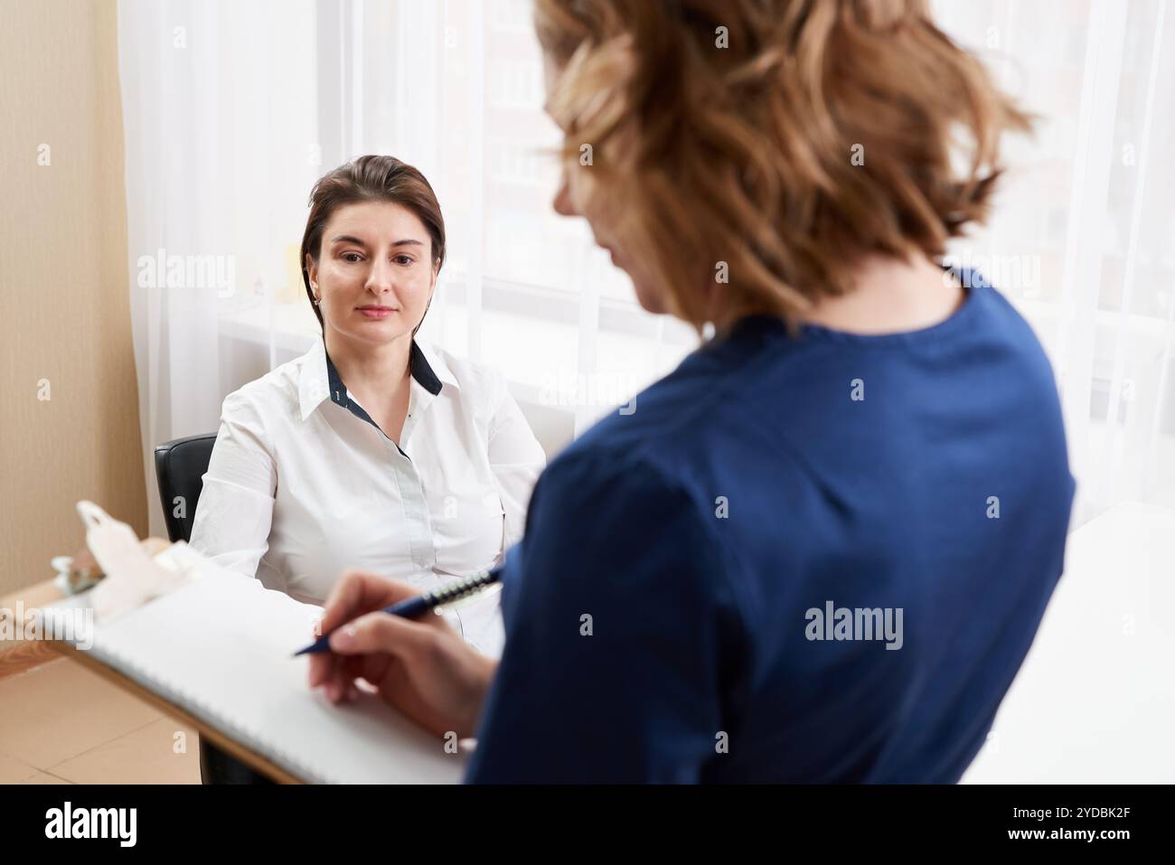 Young female doctor patient talking hi-res stock photography and images ...