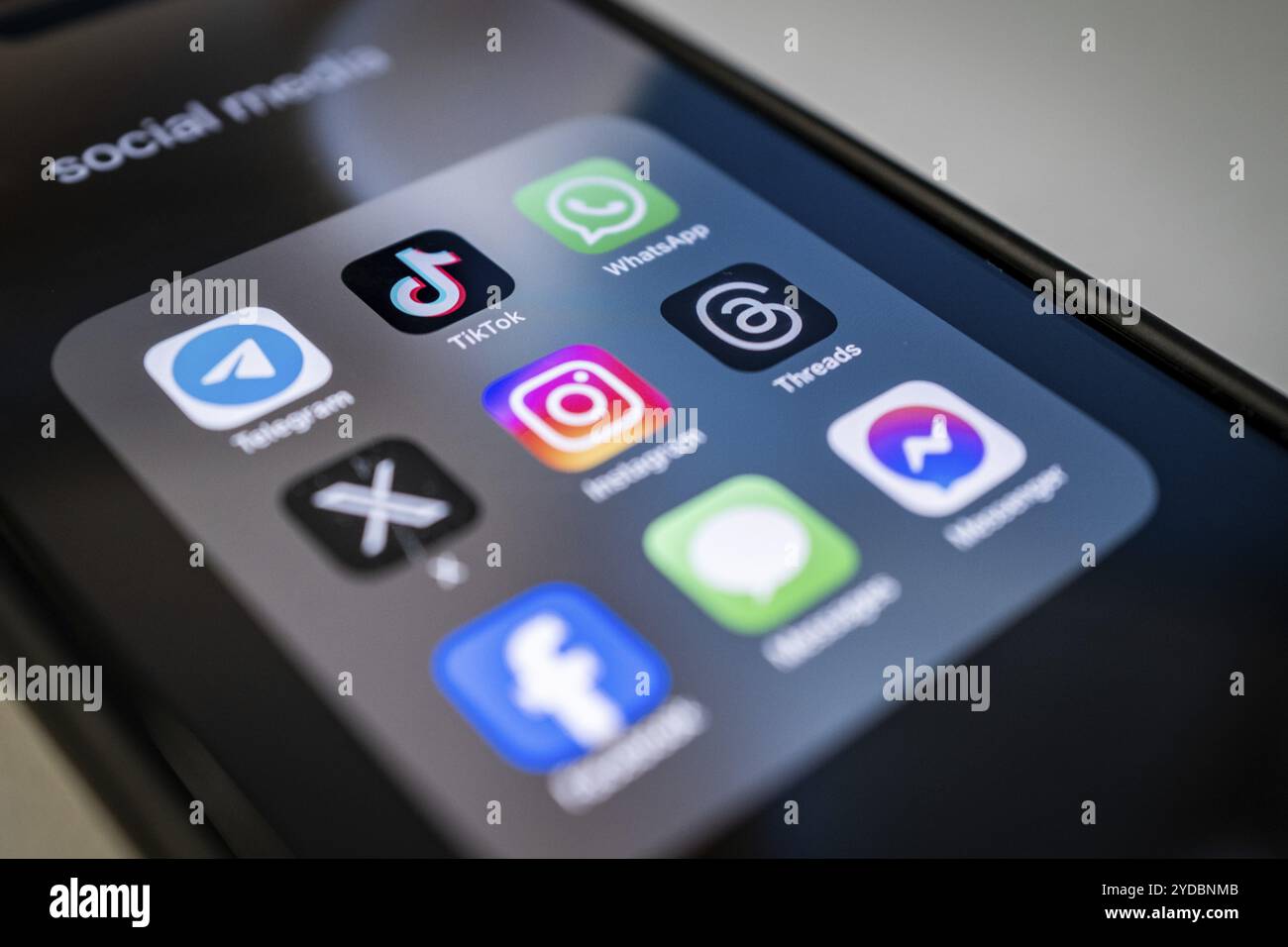 Close-up of a smartphone screen with various social media apps, diffuse ...
