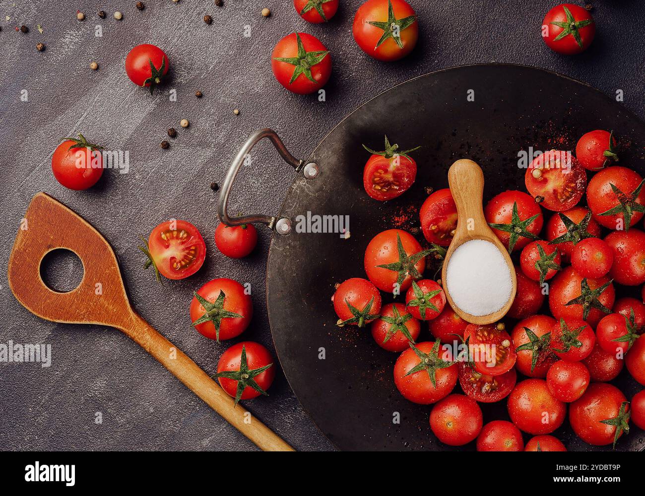 Cherry tomatoes on against black stone surface Stock Photo