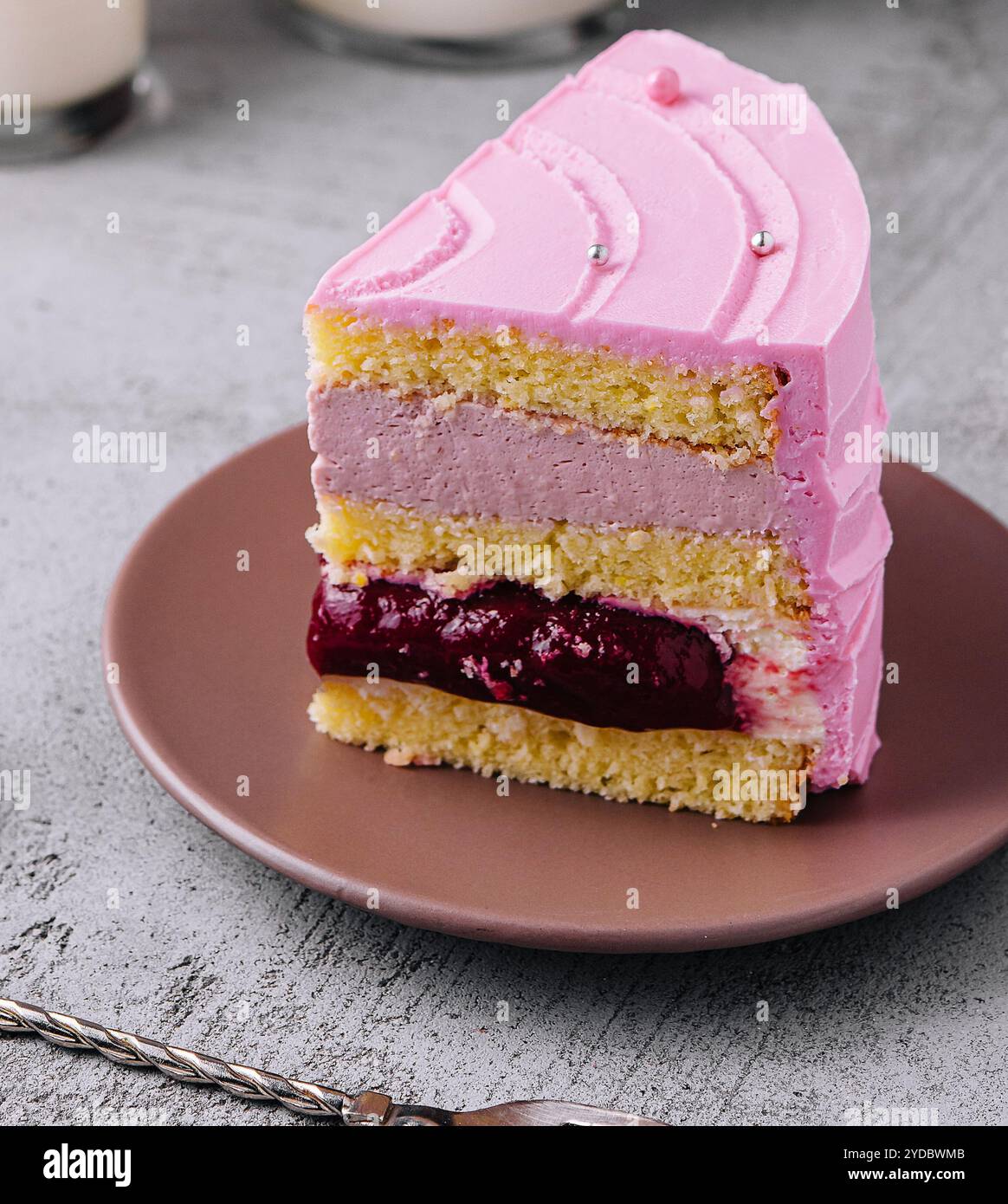 Slice of pink cake on plate close up Stock Photo