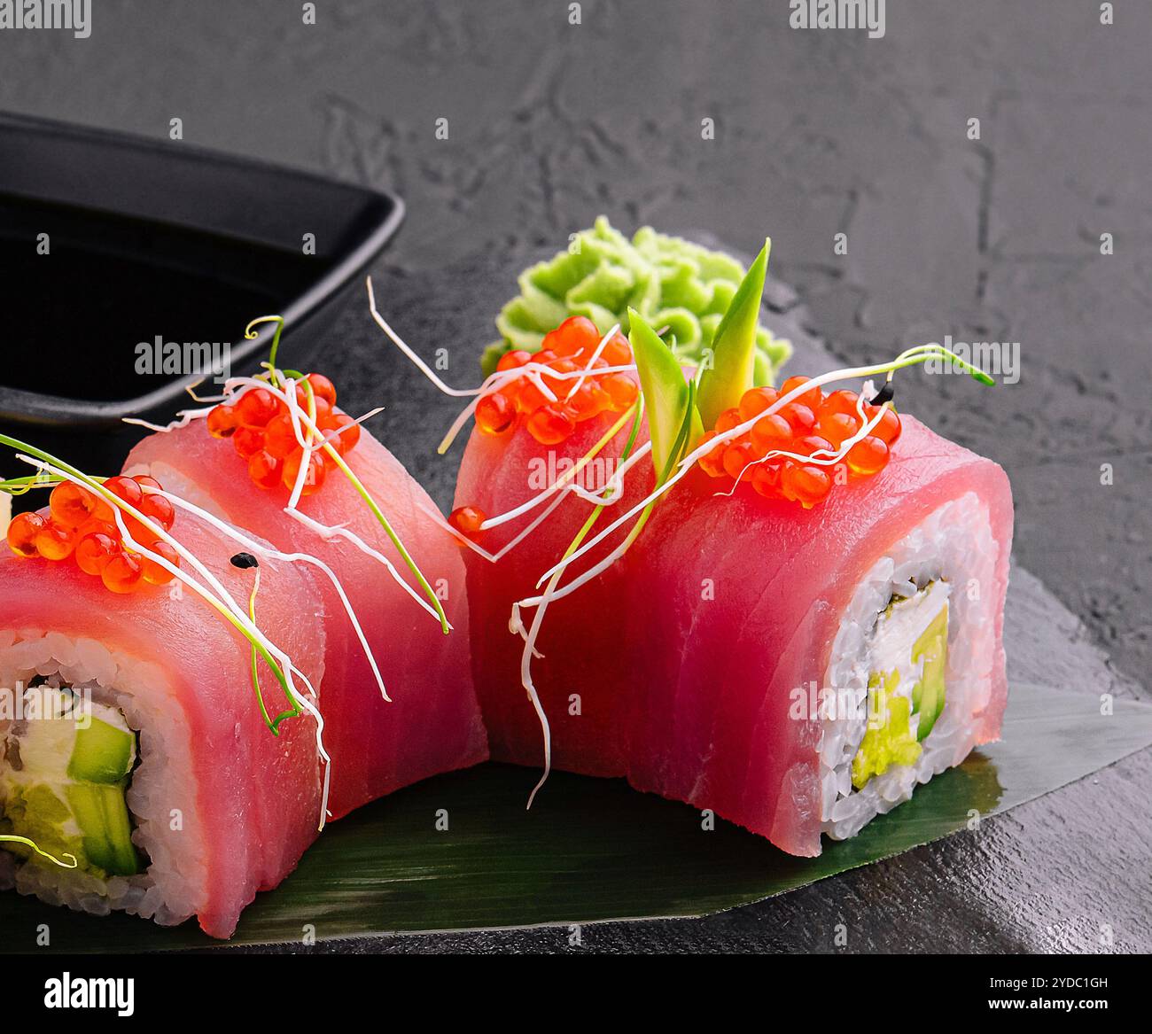 Sushi rolls of red tuna on black stone Stock Photo
