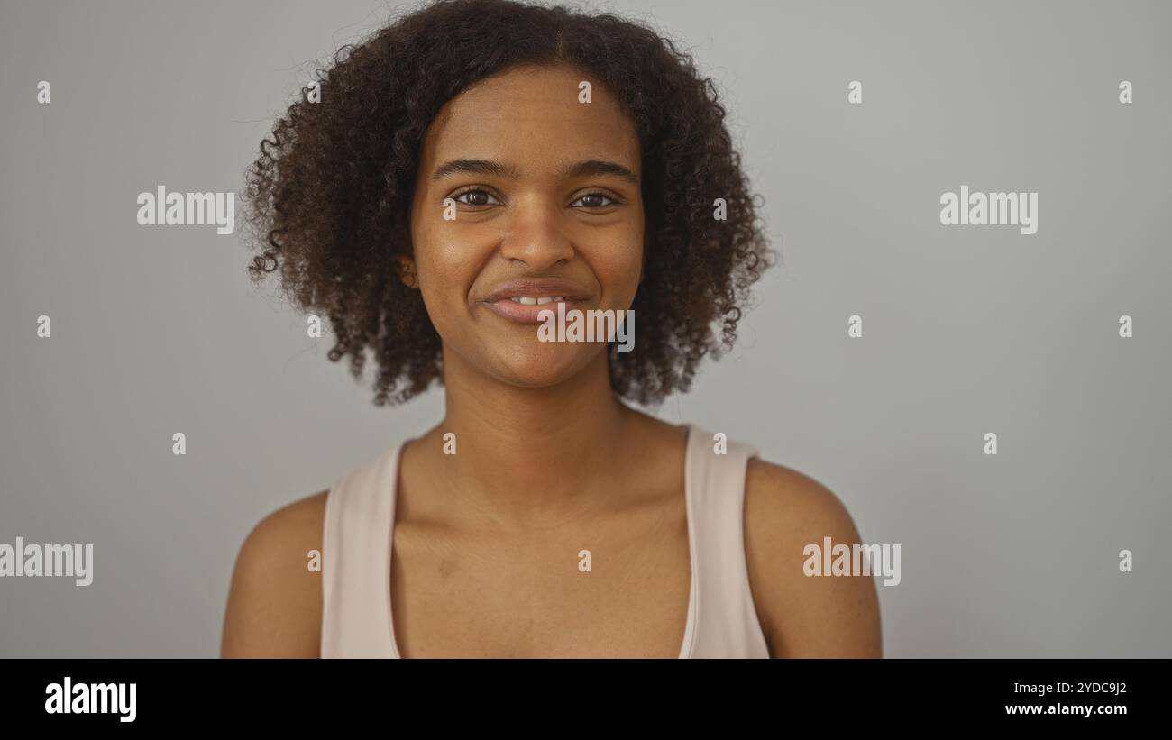 Young african american woman with curly hair smiling over isolated ...