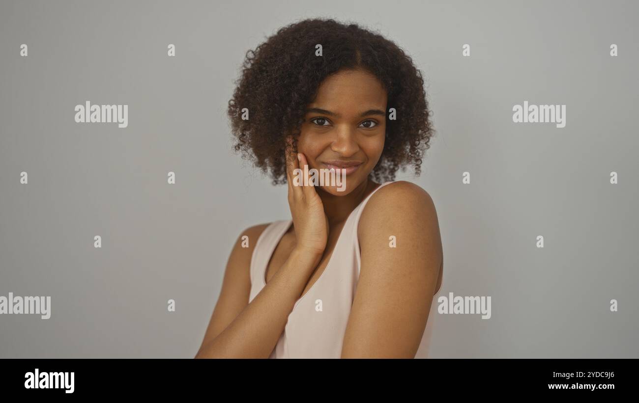 Beautiful young african american woman with curly hair posing ...