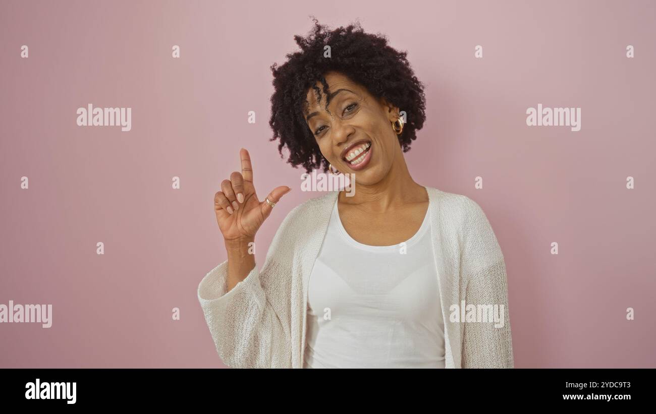A beautiful young african american woman with curly hair poses against ...