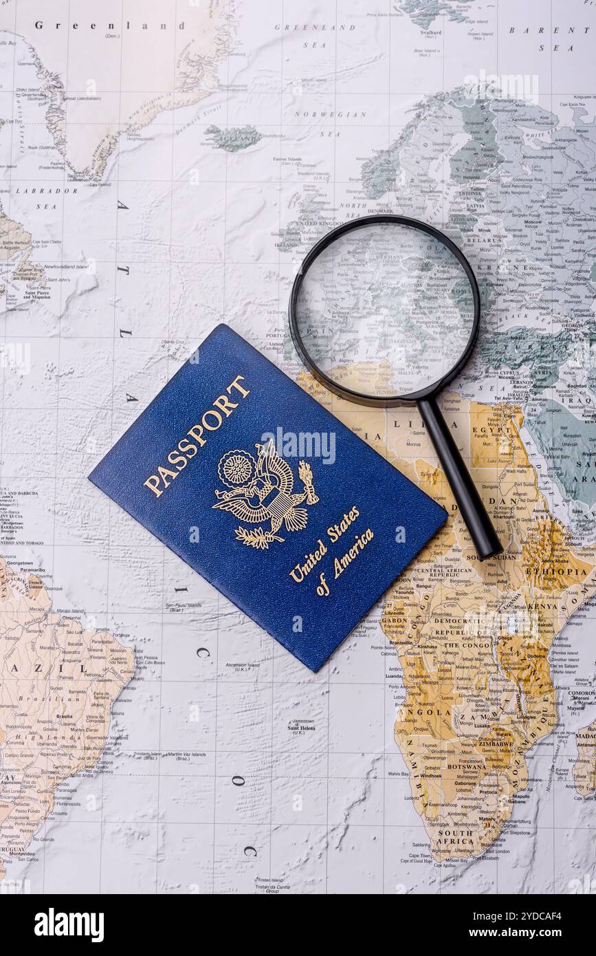 Conceptual background for travel with passport, magnifying glass, world